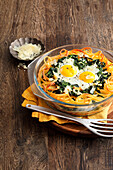 Macaroni and fried egg casserole with spinach