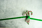 Christmas cone candy with ribbon on concrete background