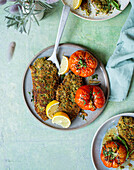 Veal escalope in a herb-panko crust served with oven-roasted tomatoes