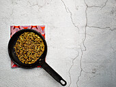 A Persian spice mix being roasted in a pan