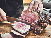 A grilled leg of lamb being sliced