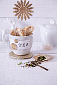 Homemade tea bags in a cup with a paper 'Tea' label