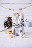 Homemade gift bag with deer motif from recycled milk carton