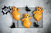 Halloween bread ghosts on a cooling rack