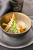 Vegetables in broth with grated goat cheese