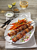 Grilled pork belly skewers with BBQ carrots