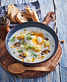 Sour dill soup with cous cous, corn and poached egg