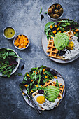 Waffles with fried egg, avocado and yellow pepper salad