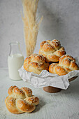 Yeast buns with sesame seeds on cake stand