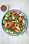 Salad with strawberries, avocado, figs and feta