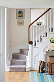 Hallway with a white painted staircase