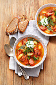 Bean stew with potatoes, sausage, and sour cream