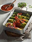 Vegetarian savoy cabbage rolls with wheat and lentils, tomato sauce and browned butter