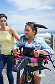 Mum and disabled daughter with rollator walking on boardwalk