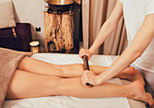 Leg massage with bamboo sticks