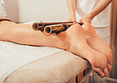 Leg massage with bamboo sticks