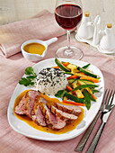 Duck breast with orange sauce and zucchini-carrot vegetables