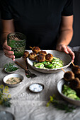 Meatballs on skewers with cucumber salad