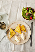 Polenta with fresh goat cheese cream and salad