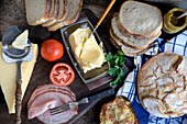 Bread, butter, cheese, and ham, ingredients to make sandwiches