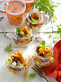 Carrot antipasti with olives served in jars