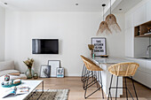 Kitchen with counter and bar stools in bright, open living room