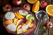 Christmas punch with fruit in a glass jar