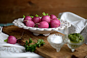 Blanched radishes in a decorative bowl with herb chimichurri