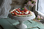 Pistachio pavlova with rhubarb cream and berries