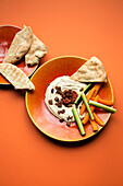 Hummus with vegetable sticks and pita bread