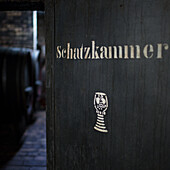 Opened door to a wine cellar with the inscription 'Schatzkammer' (treasure trove)