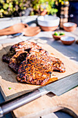 Grilled steaks on a wooden cutting board