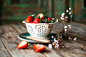 Fresh strawberries in a vintage colander