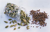 Cellophane bag with green cardamom and a bunch of cardamom seeds