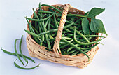 French beans in a basket on a light background