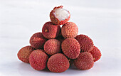A pile of lychees on a light background