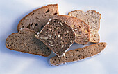 Different slices of wholewheat bread on a light background