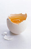 Egg in a broken egg shell on a light background