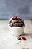A gluten-free muffin made with walnut flour, cocoa, cardamom and cranberries