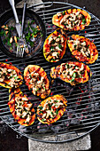 Grilled papayas stuffed with lime chicken on a grill rack