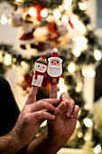Close-up of hands with finger puppets of Santa and snowman