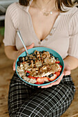 Woman holding granola bowl