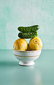 Lemon cucumbers and gherkins in porcelain bowl