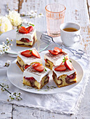 Sweet sponge cake bars with pudding and strawberries