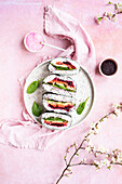 Rainbow onigirazu sandwiches with spinach, roasted beet, avocado, smoked salmon, sprinkled with furikake
