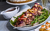 New Year's Eve menu - roast beef with apples, green beans, and port wine sauce