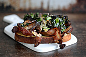 Warm mushroom sandwich with black cabbage, bacon, and Västerbotten cheese