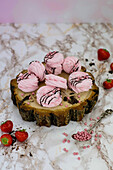 Strawberry biscuits on a tree slice