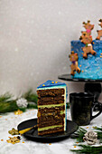 Chocolate pistachio cake decorated with reindeer biscuits for Christmas