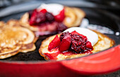 Pancakes with blackberry compote and cream